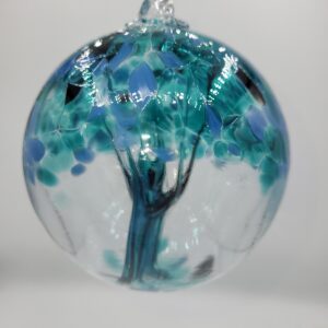 Glass orb with blue tree design