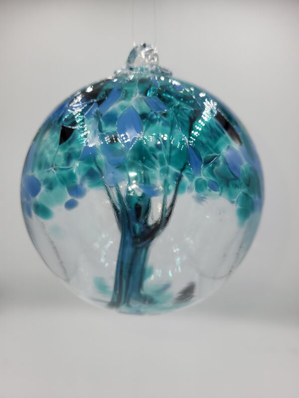 Glass orb with blue tree design