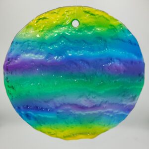Colorful, round glass ornament with rainbow hues.