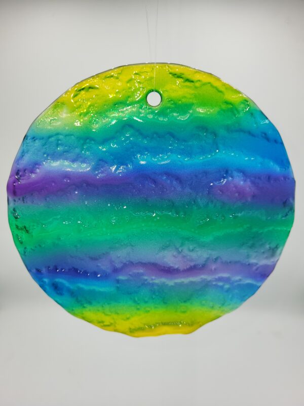 Colorful, round glass ornament with rainbow hues.