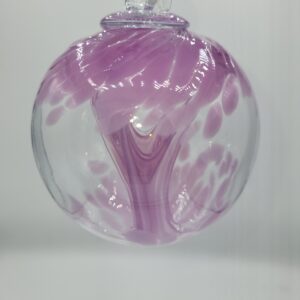 Purple swirled glass ornament hanging on display.