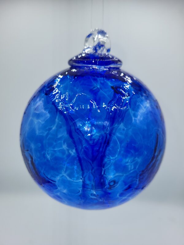 Blue glass ornament with textured surface.