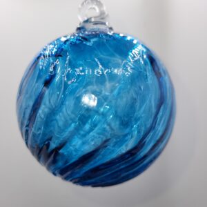 Blue glass ornament with swirling patterns