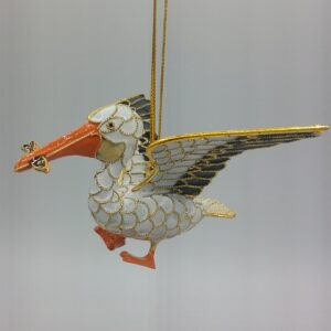 Decorative pelican ornament with gold and orange details.