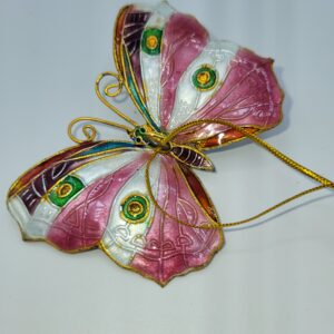 A decorative butterfly ornament with pink, white, and green patterned wings, gold accents, and a thin gold hanging string, displayed on a white background.