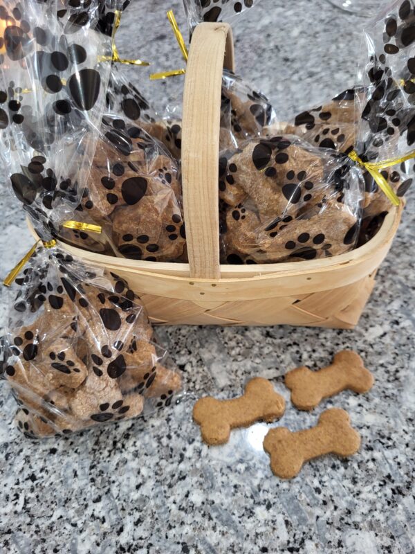 Basket with dog treats in paw print bags.