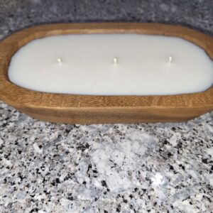 Wooden bowl candle on granite countertop