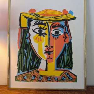 Colorful abstract framed artwork on wall.