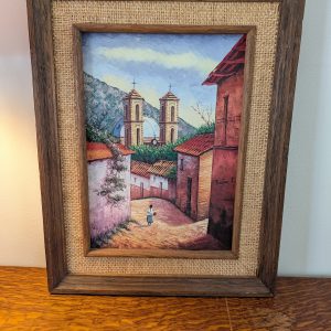 Framed painting of a village scene